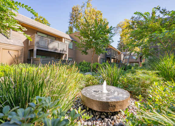 Landscaped walkway with seating area and apartment buildings