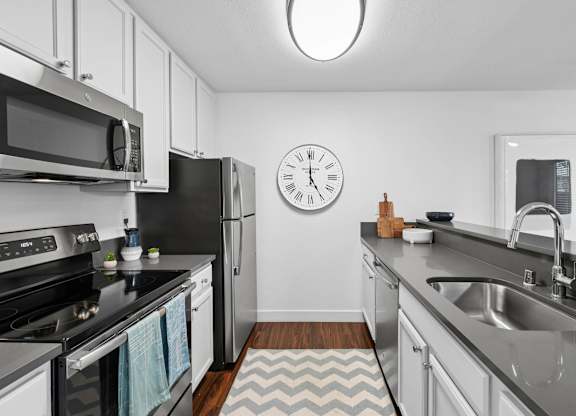 Kitchen with appliances and functional layout at Old Orchard Apartments