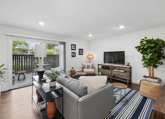 Living room with sofa and open floor plan at Old Orchard Apartments