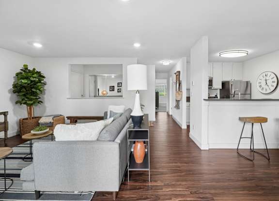 Dining area with round table, chairs, breakfast bar seating, and adjacent kitchen