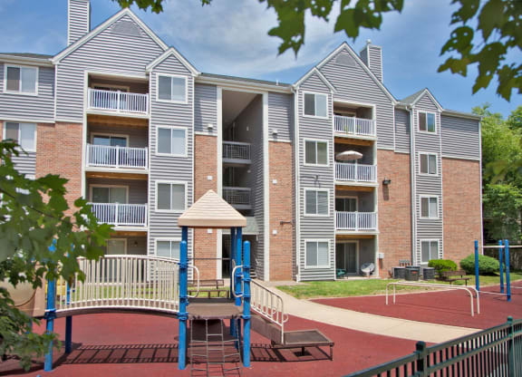 an image of a playground in front of an apartment building