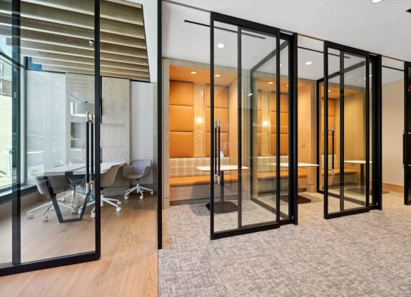 a conference room with glass walls and a table and chairs
