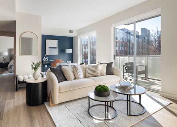 A modern living room with a large window and a view of the city.