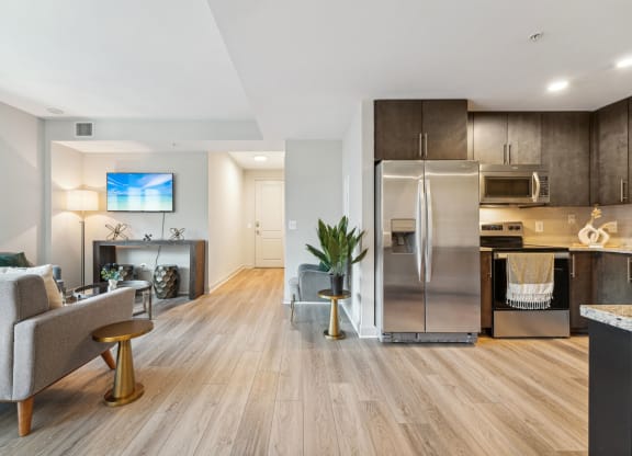 A living room with a view of the kitchen