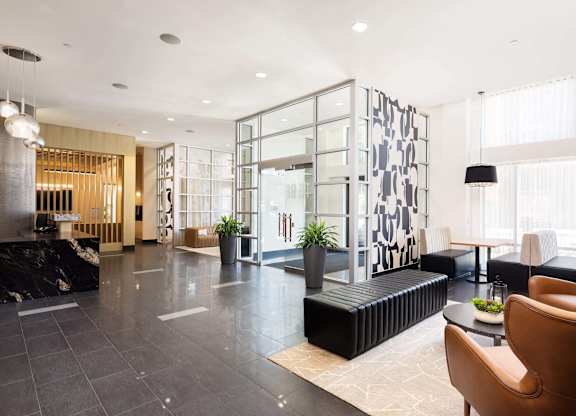 the lobby of a hotel with chairs and couches