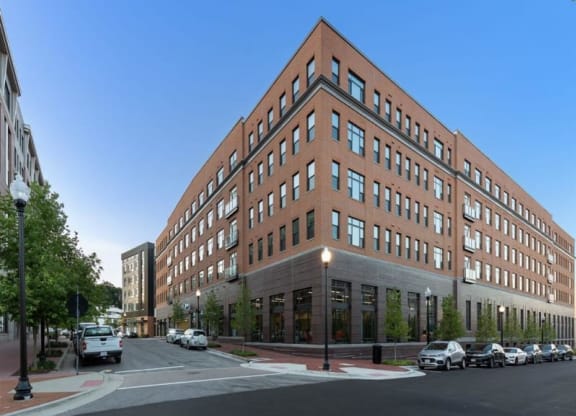 a large brick building on the corner of a city street