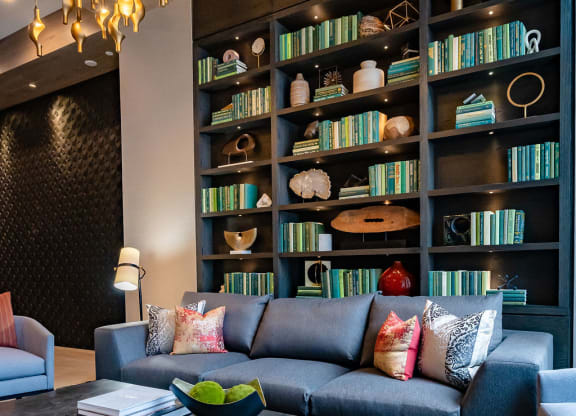 a living room with a couch and a bookshelf