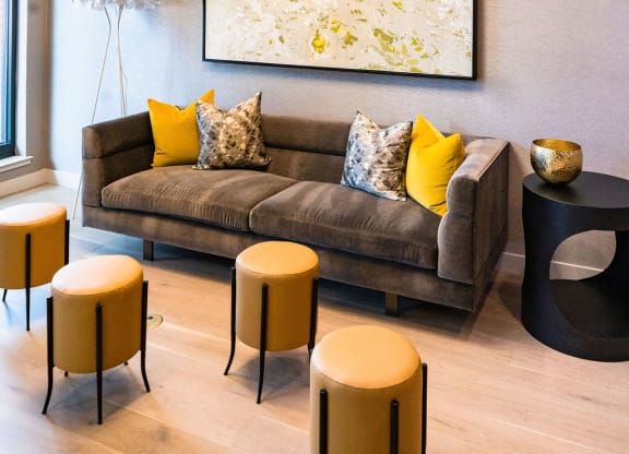 a living room with a couch and a painting on the wall
