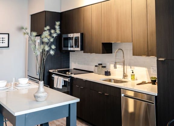 a kitchen with wooden cabinets and stainless steel appliances