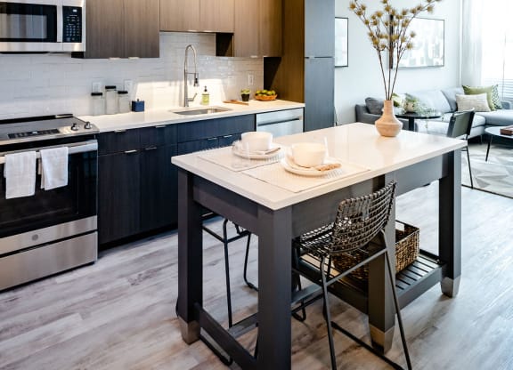 a kitchen with a center island and a dining table
