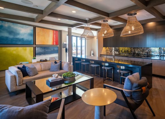 a living room and kitchen with couches and chairs