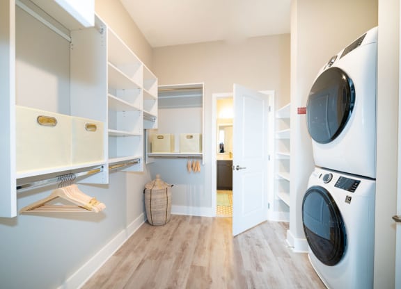 a washer and dryer in a laundry room with a closet