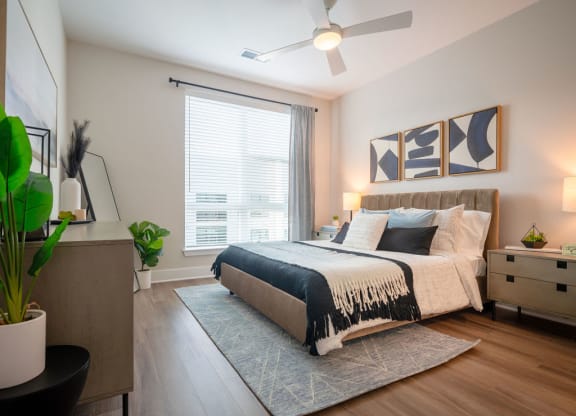 a bedroom with a bed and a ceiling fan