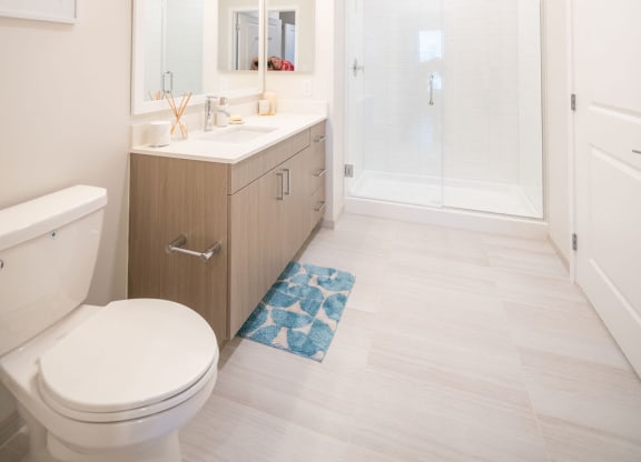 a bathroom with a toilet and a sink and a shower