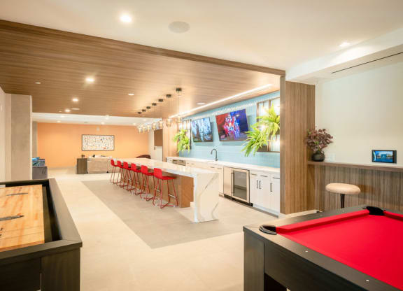 a billiards room with a pool table and a bar
