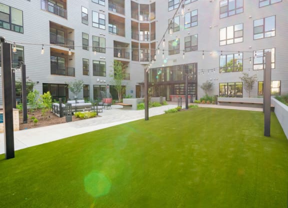 a large green lawn in front of an apartment building
