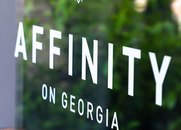 the logo for affinity on the front of a glass window