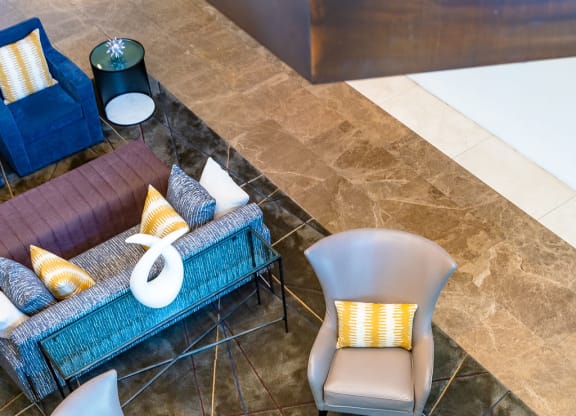 a living room with couches and chairs and a table