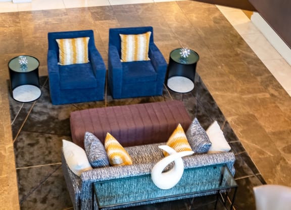 a seating area with couches and chairs in a lobby