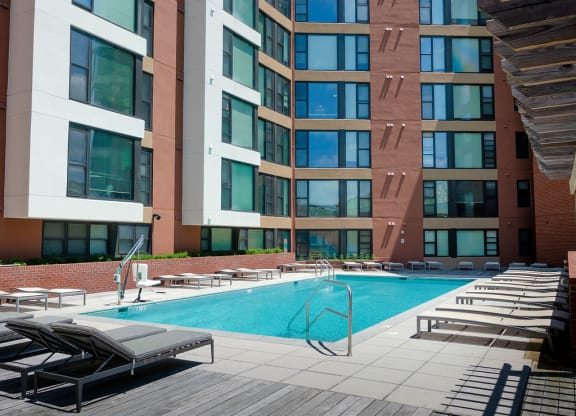 a building with a swimming pool in front of it