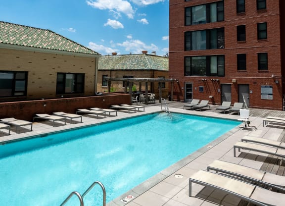 a swimming pool at a hotel in front of a building