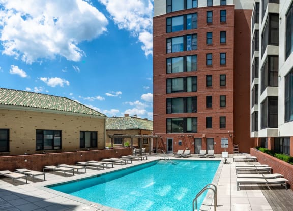a swimming pool in the middle of two tall buildings
