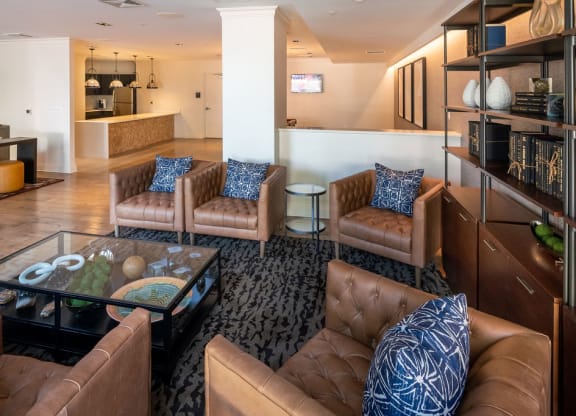 a living room with couches and a glass coffee table
