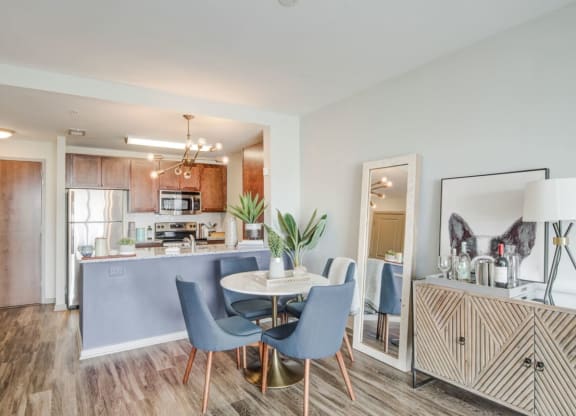 a dining room and kitchen with a table and chairs