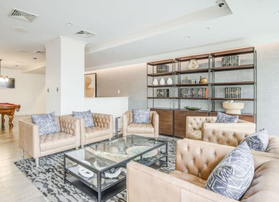 a living room with couches and a glass coffee table