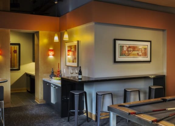 a room with a pool table and a bar