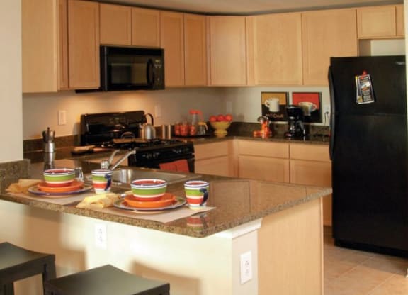 a kitchen with a counter with plates on it