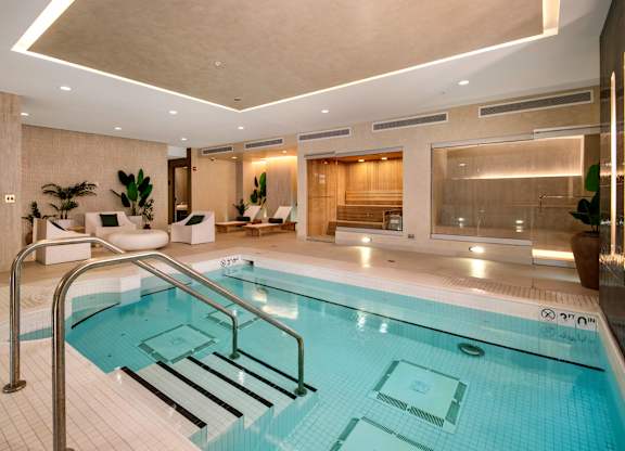 Spa featuring access to both sauna and steam room with sleek, contemporary finishes.