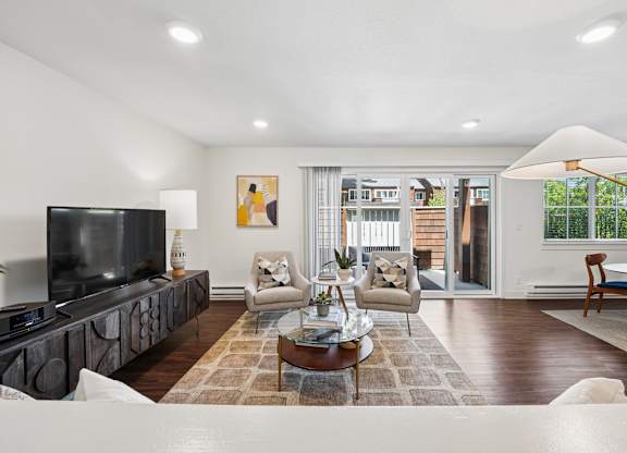 A modern living room with a flat screen TV and a coffee table.