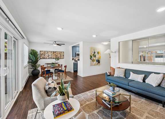 A living room with a blue couch and a coffee table.