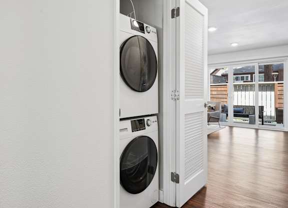 A white washing machine and dryer in a laundry room.