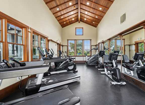 Gym with treadmills, ellipticals, and bikes at Pescadero Apartments in Redwood City