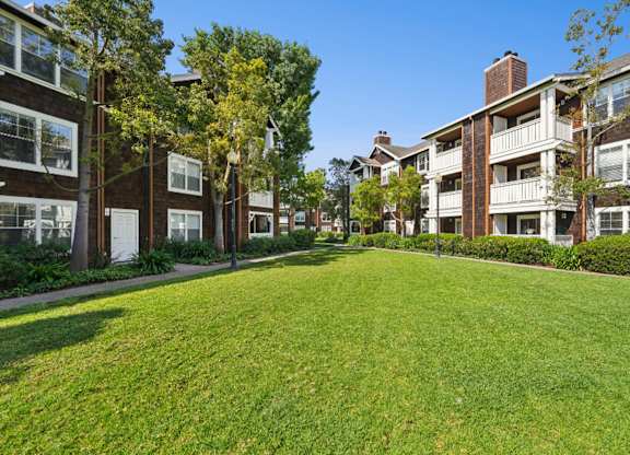 landscaped apartment grounds with greenery and pathways