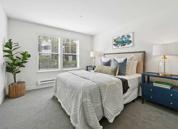 Bright bedroom at Pescadero Apartments with soft finishes, plush carpeting, and spacious closet storage.