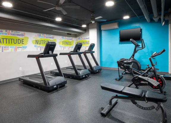 a gym with treadmills and other exercise equipment