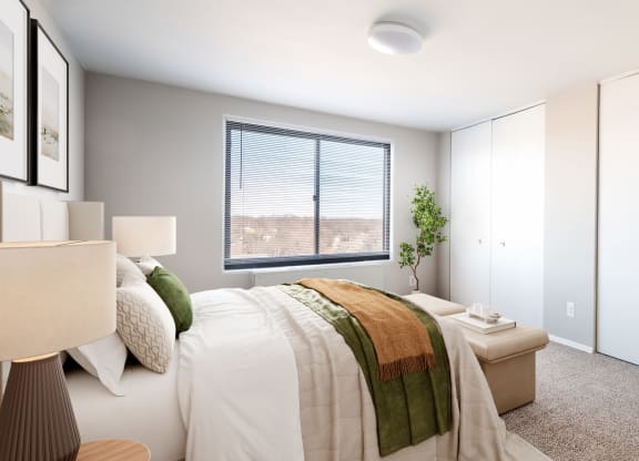 an empty bedroom with a bed and a window