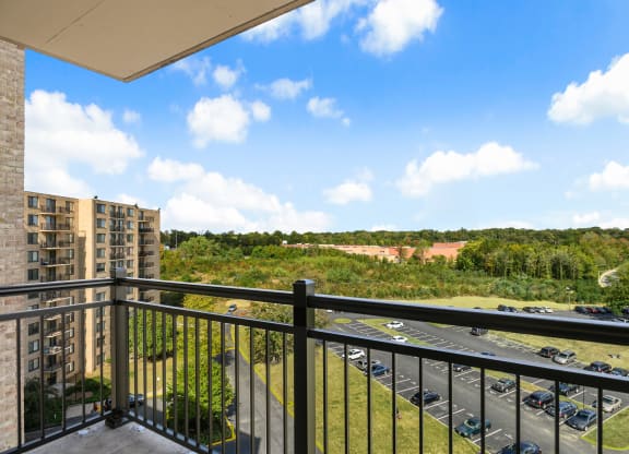 the view from the balcony of an apartment building overlooking a parking lot