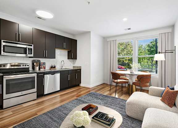 A modern kitchen with a dining area and a couch.