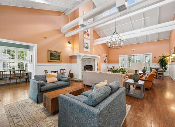 A living room with a grey couch and a fireplace.