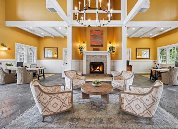Leasing office with welcoming seating, workspaces, and contemporary interior finishes at The Presidio Apartments.