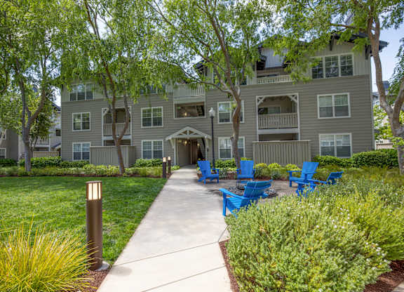 A large building with a balcony and a walkway in front of it.