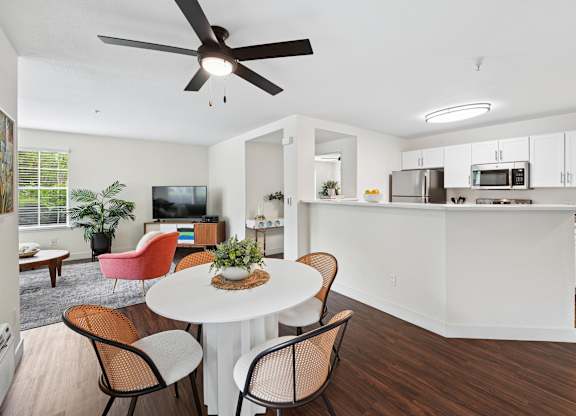 A modern kitchen with a dining table and chairs.