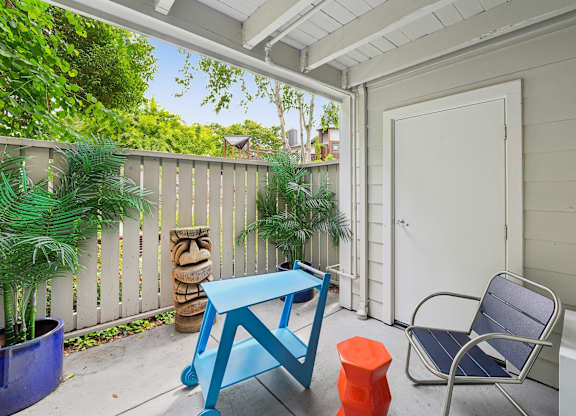 A blue table and chair set on a patio.