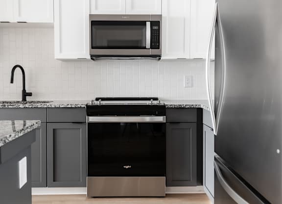 A modern kitchen with a refrigerator on the right.