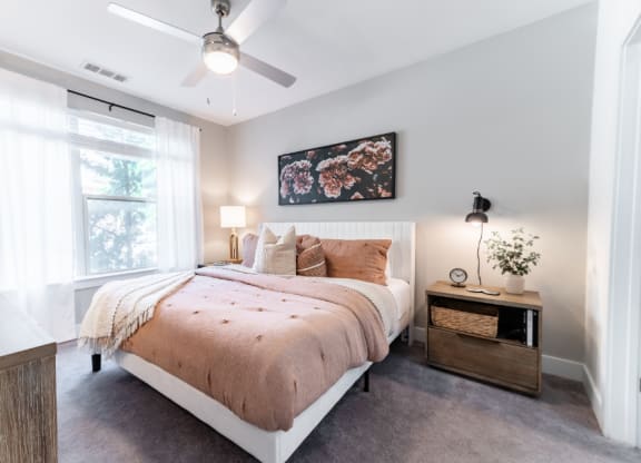 a bedroom with a bed and a ceiling fan