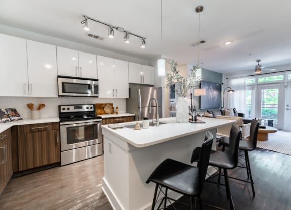 a kitchen and living room with a white counter top